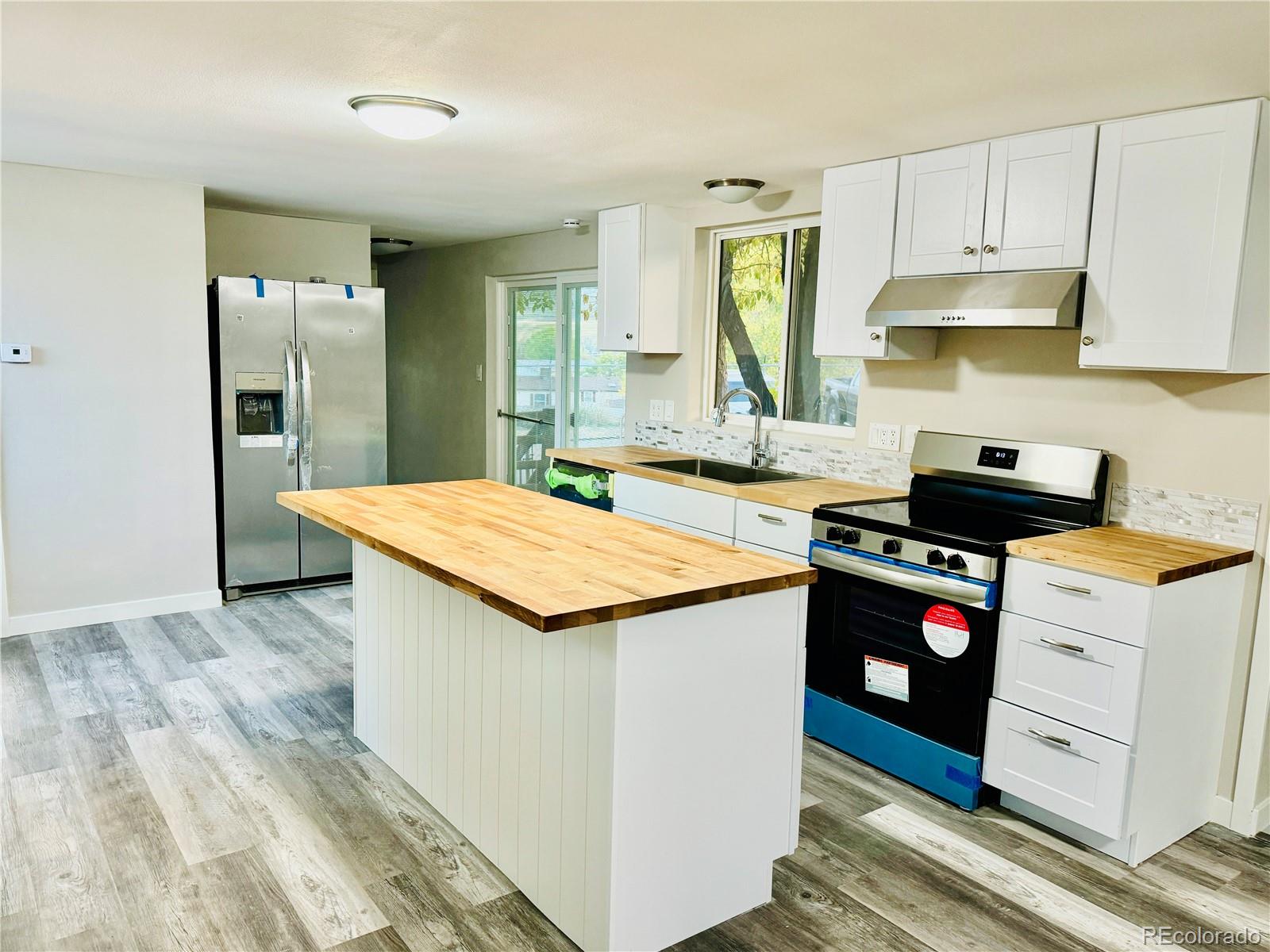 a kitchen with stainless steel appliances granite countertop a sink and cabinets