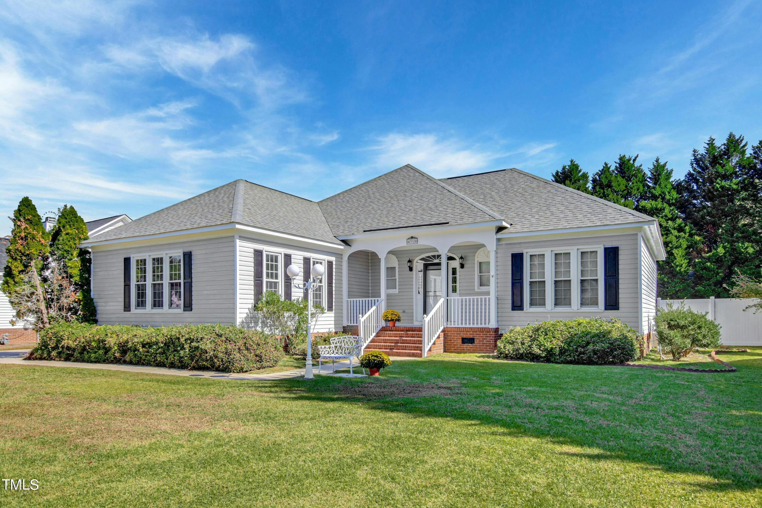 a front view of a house with a yard and porch