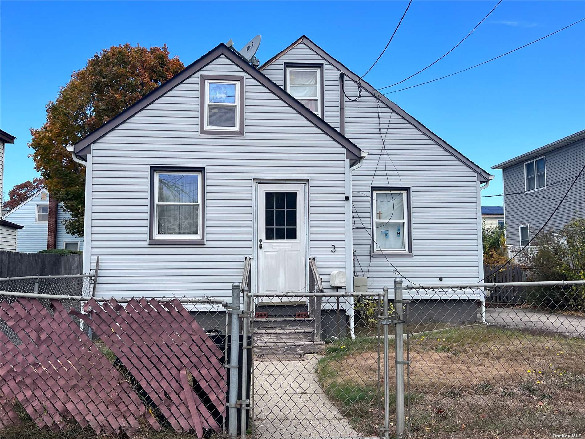 a view of a house with wooden fence