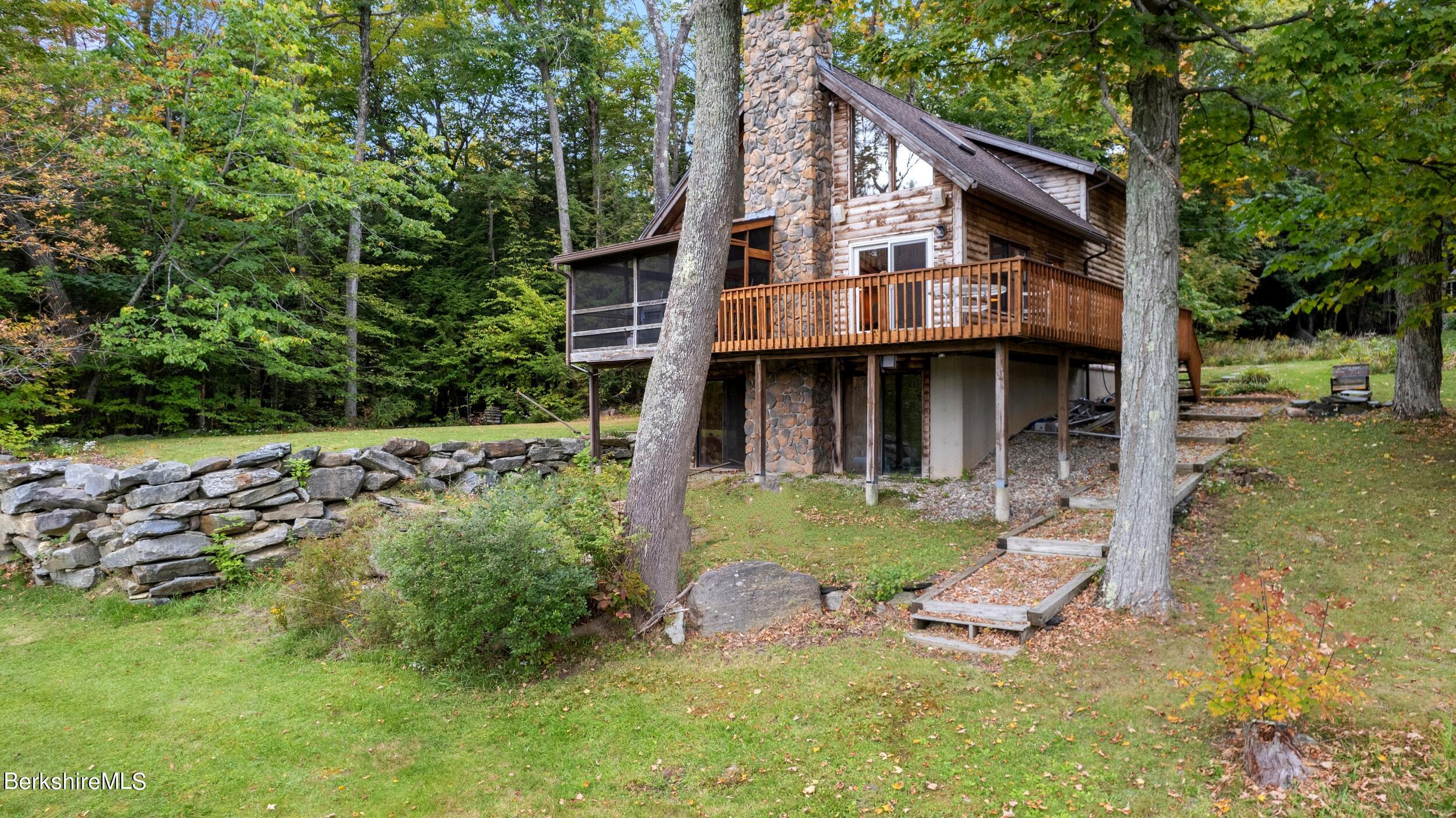 a view of a house with backyard sitting area and garden