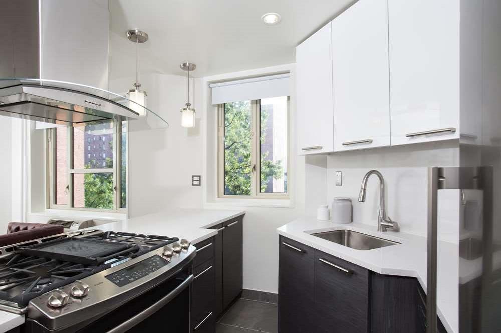 a kitchen with a stove a sink and a window