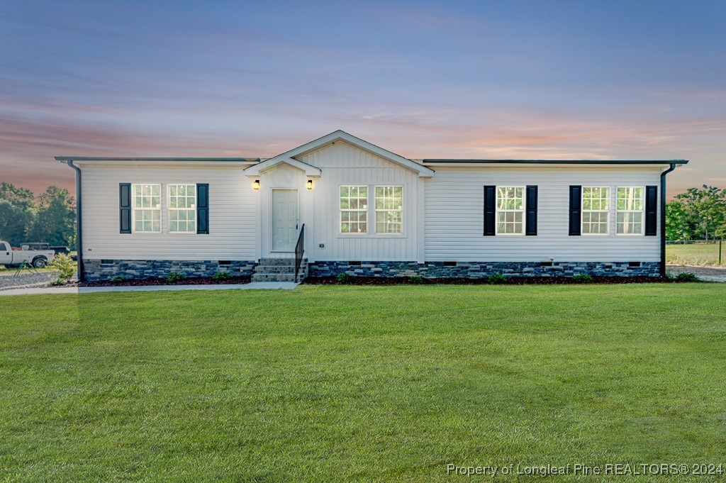 a front view of house with yard and green space