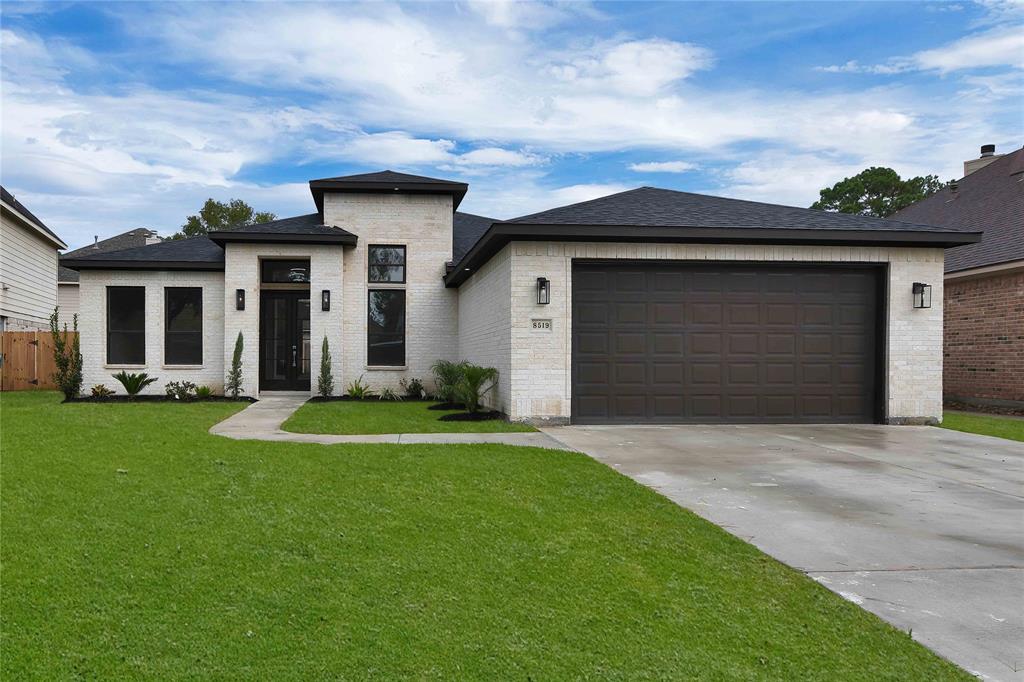 a front view of a house with a yard and garage