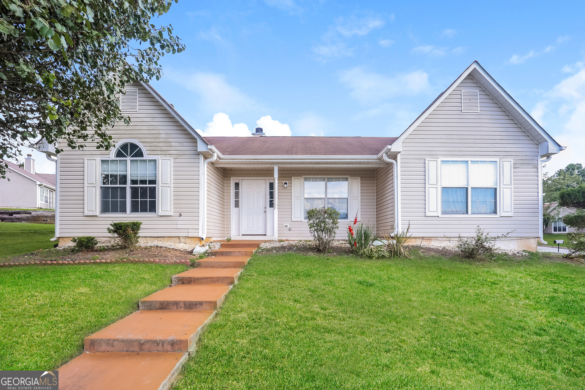 a front view of a house with a yard and porch