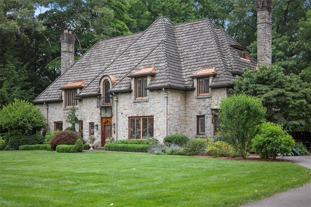 a front view of a house with a garden