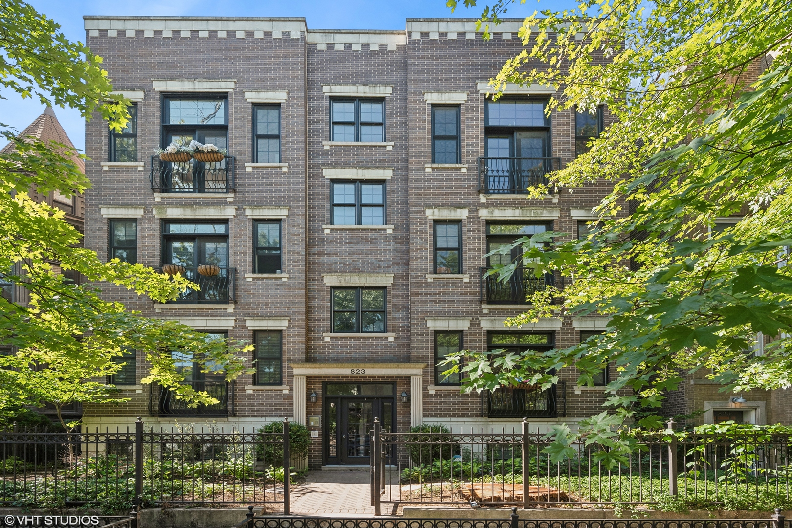 a front view of a multi story building with a yard