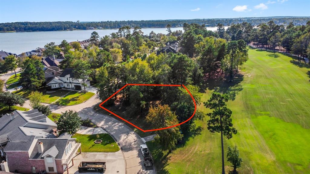 an aerial view of a house with a garden and lake view