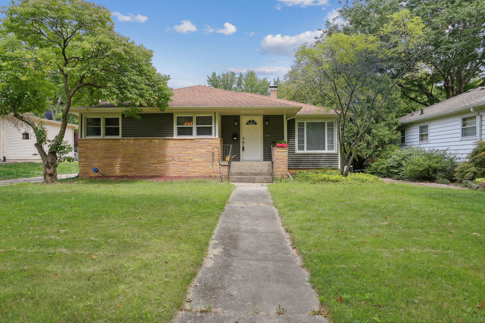 a front view of house with yard and green space