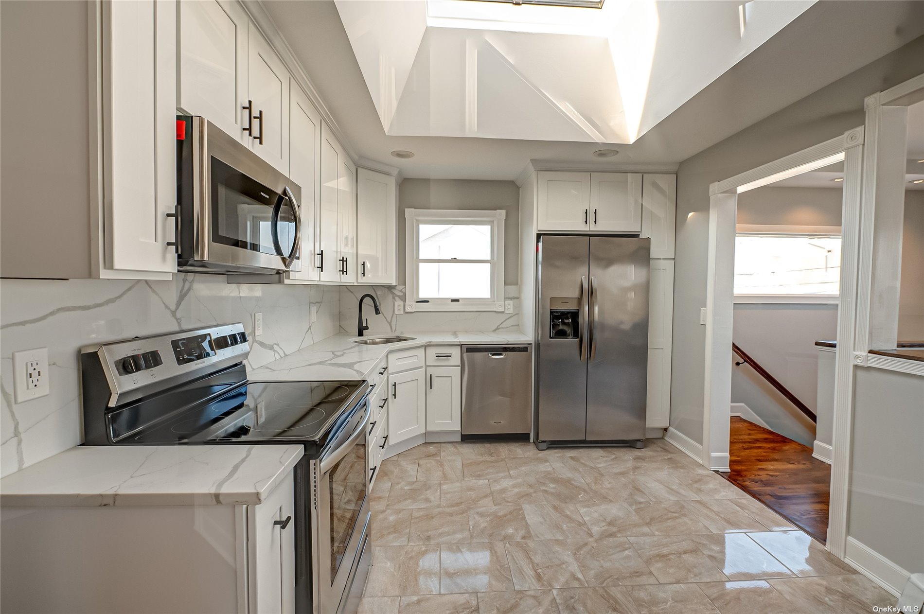 a kitchen with a sink stove and refrigerator