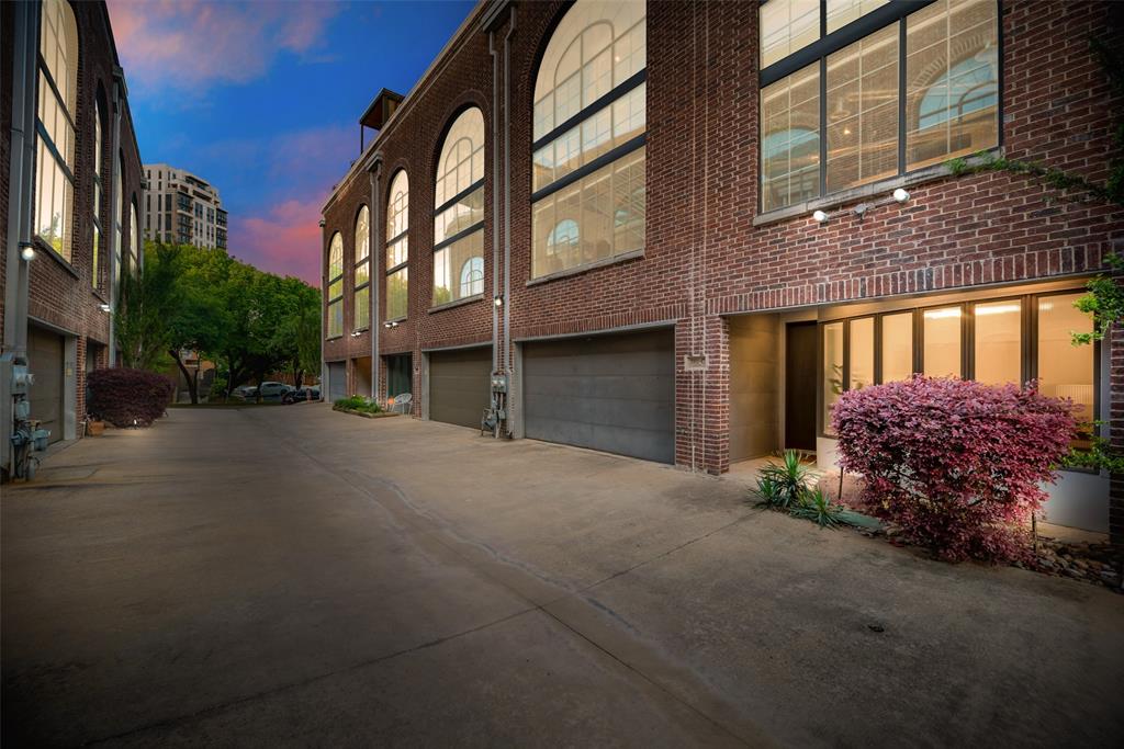 a couple of cars parked in front of brick building