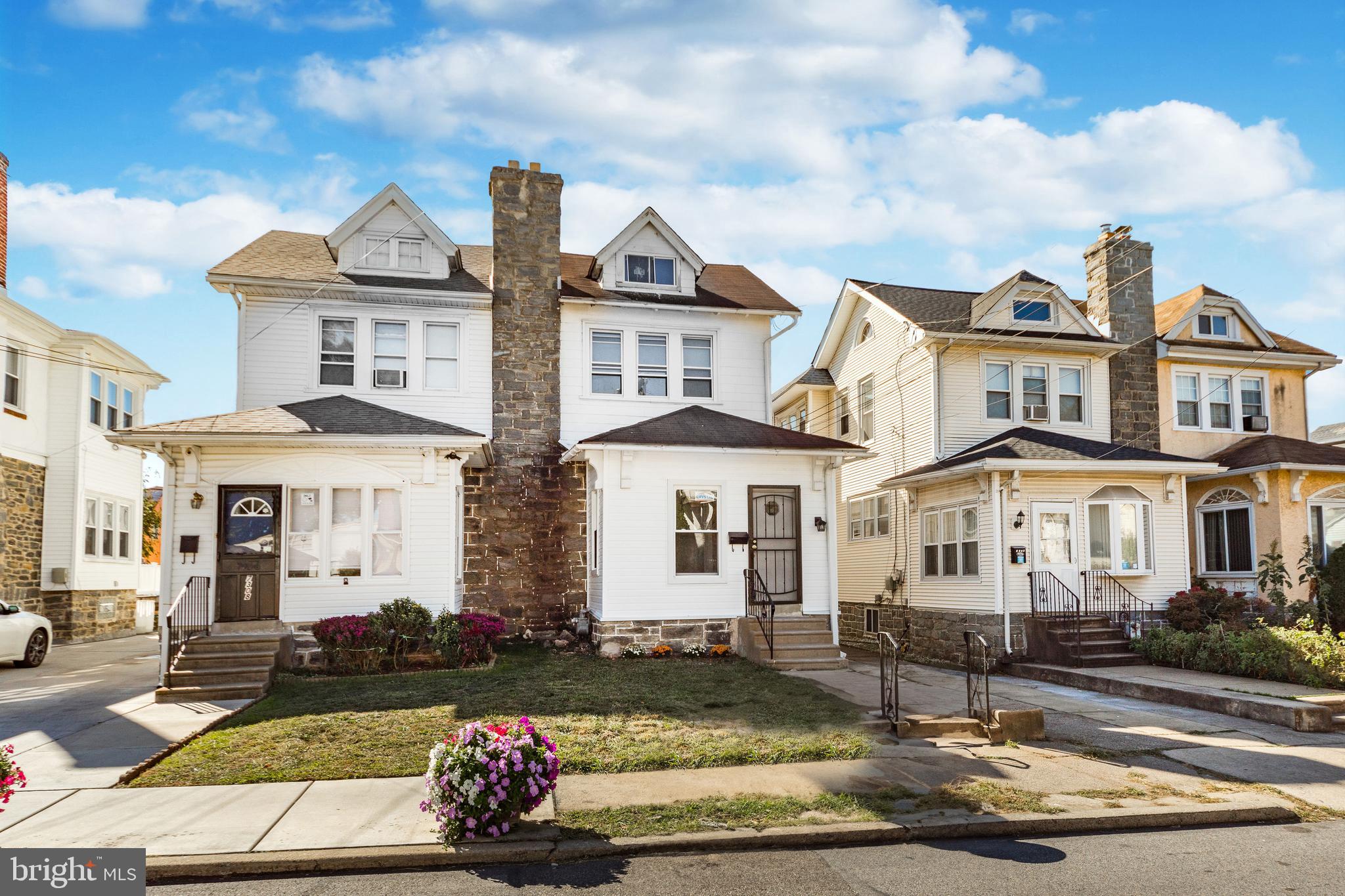 a front view of a residential apartment building with a yard