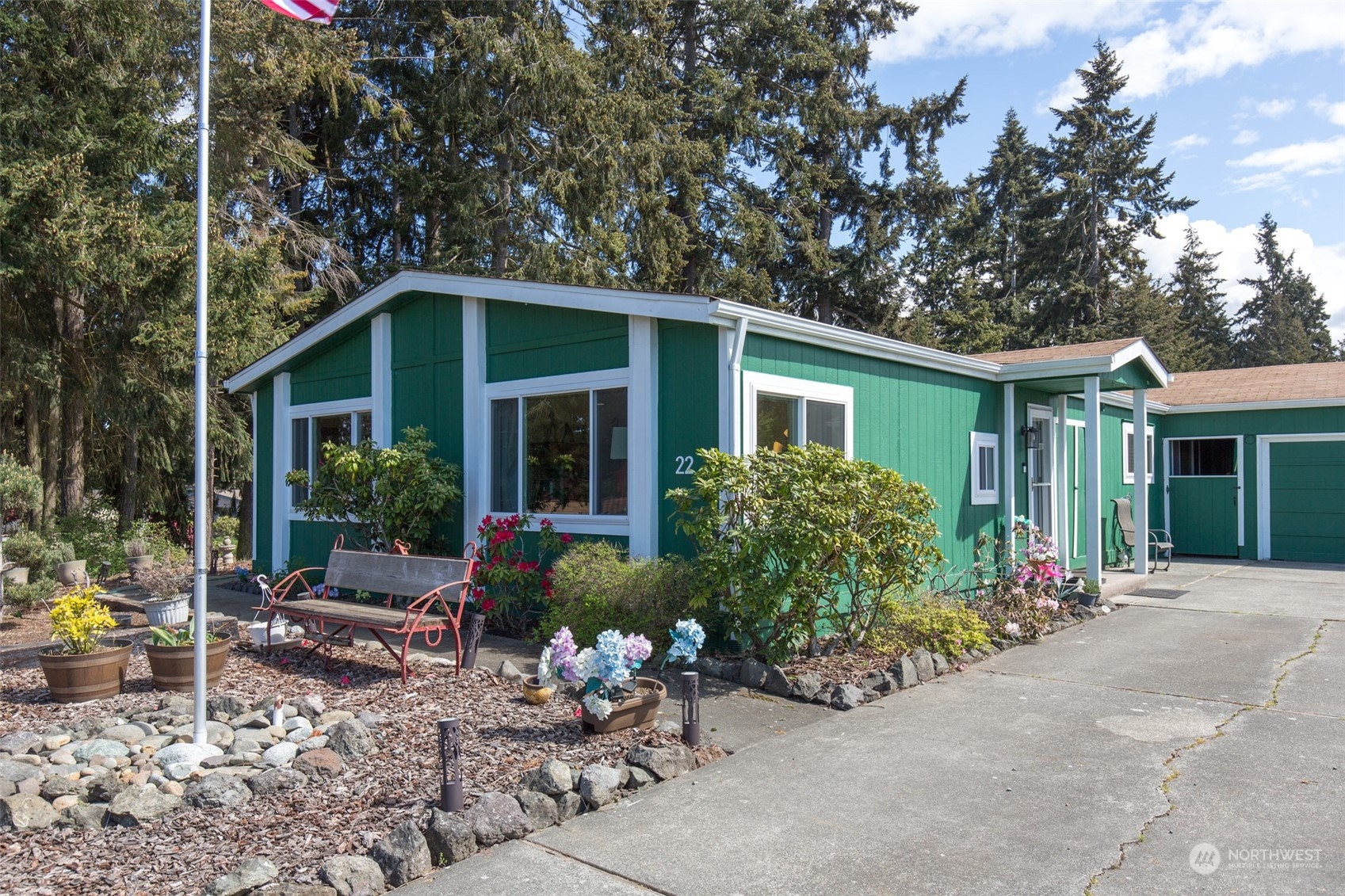 a view of a house with backyard sitting area and garden