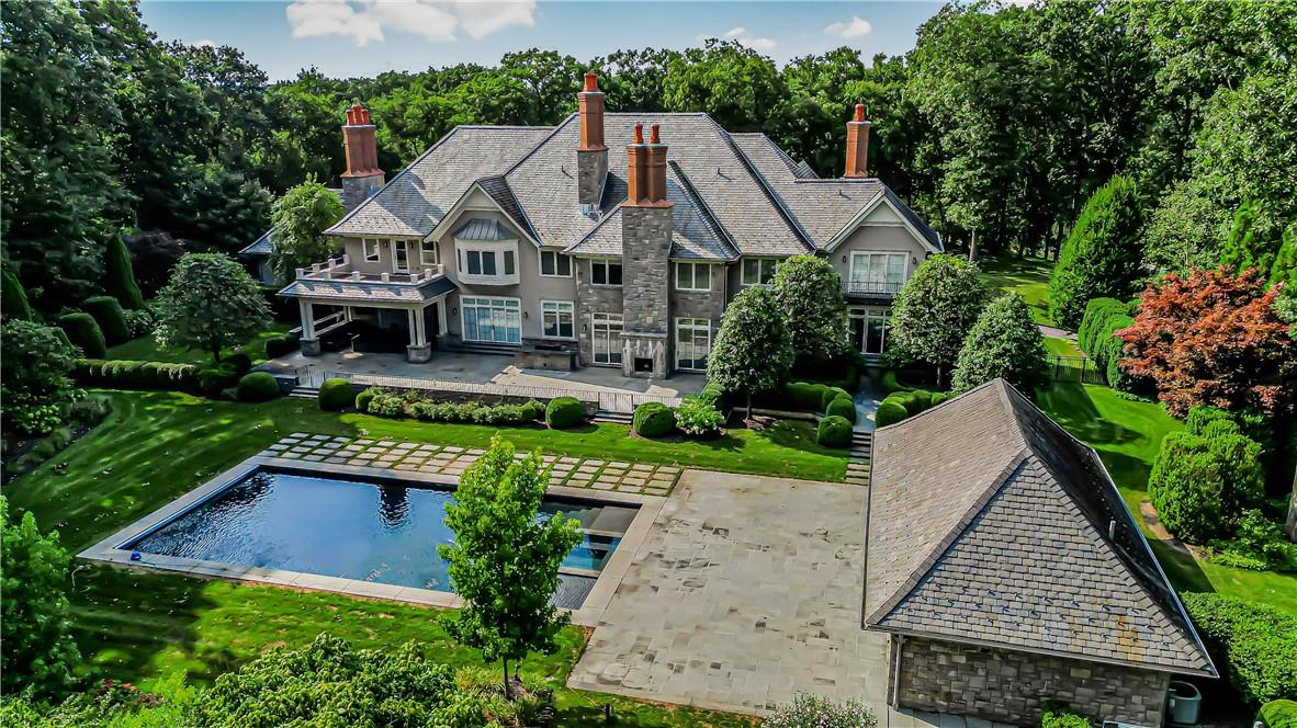 Rear view of property featuring a lawn, pool and a patio area