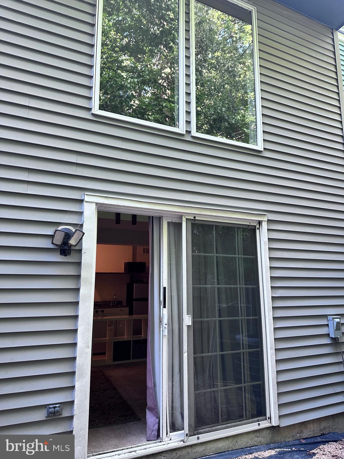 a view of a house with a large window and stairs