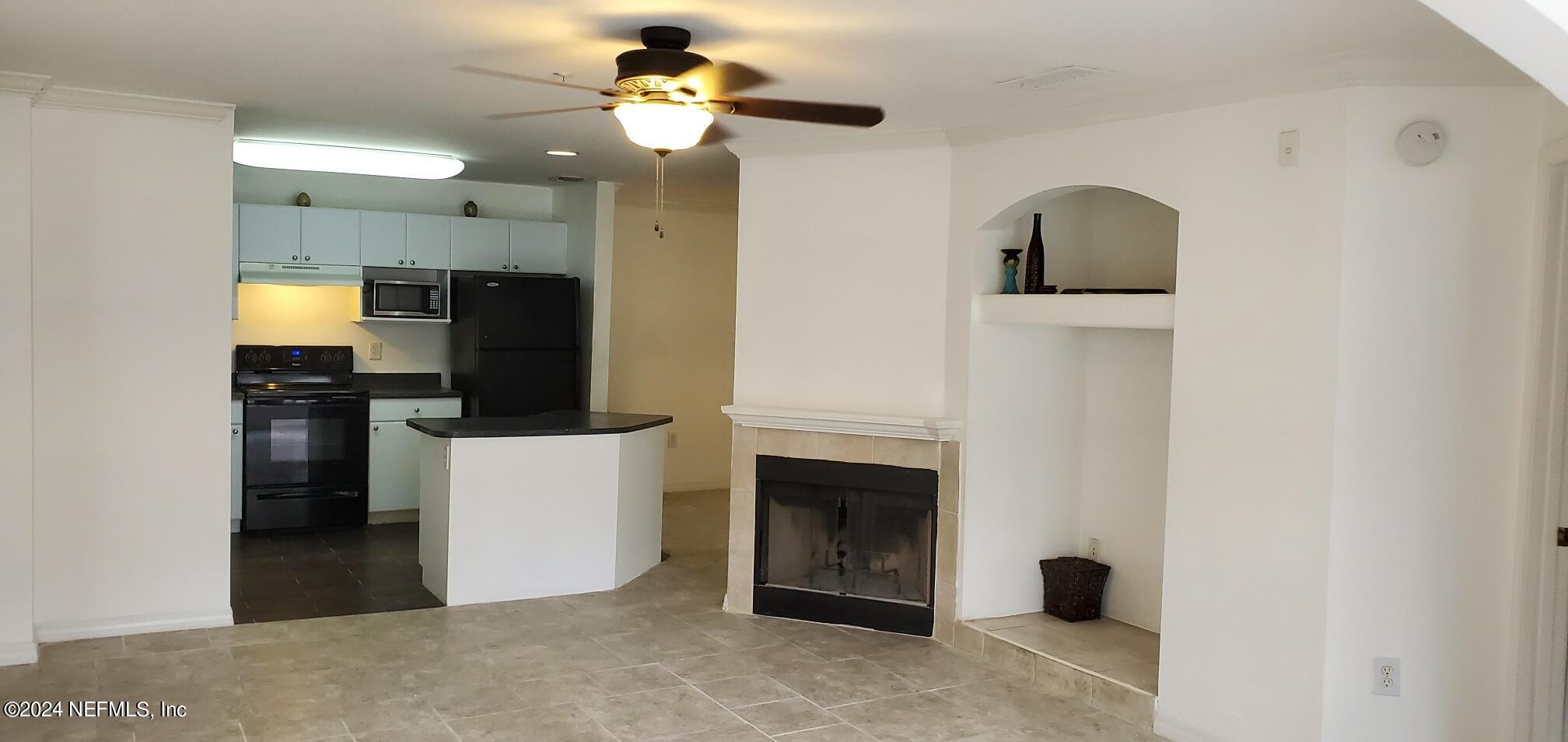 a view of a kitchen with a sink and a fireplace