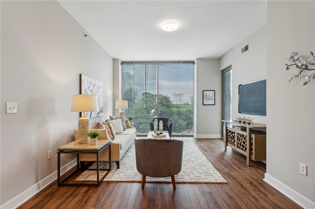 a living room with furniture and a flat screen tv