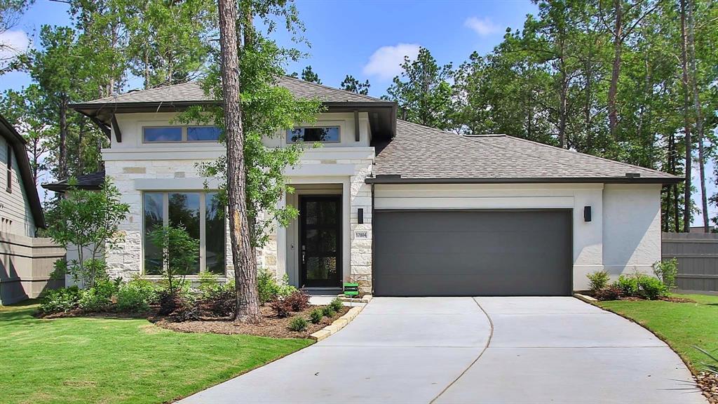 a front view of a house with a garden and yard