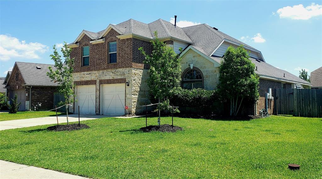 a view of a house with a yard and a garden