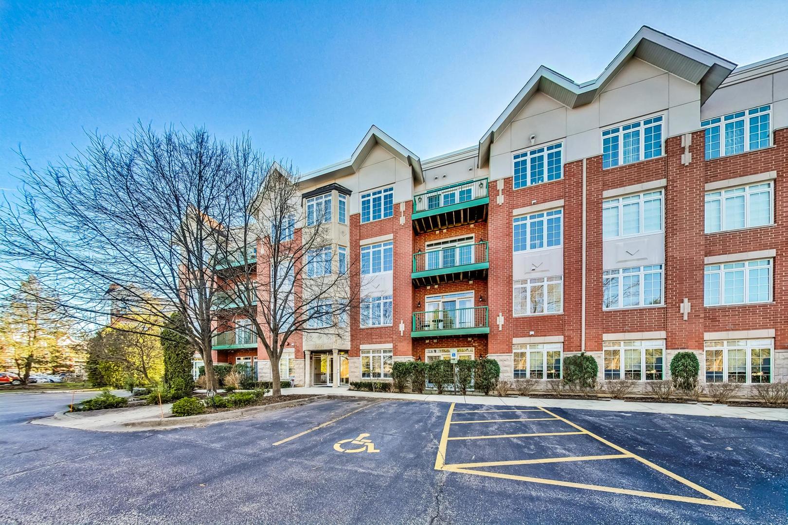 a front view of a residential apartment building with a yard