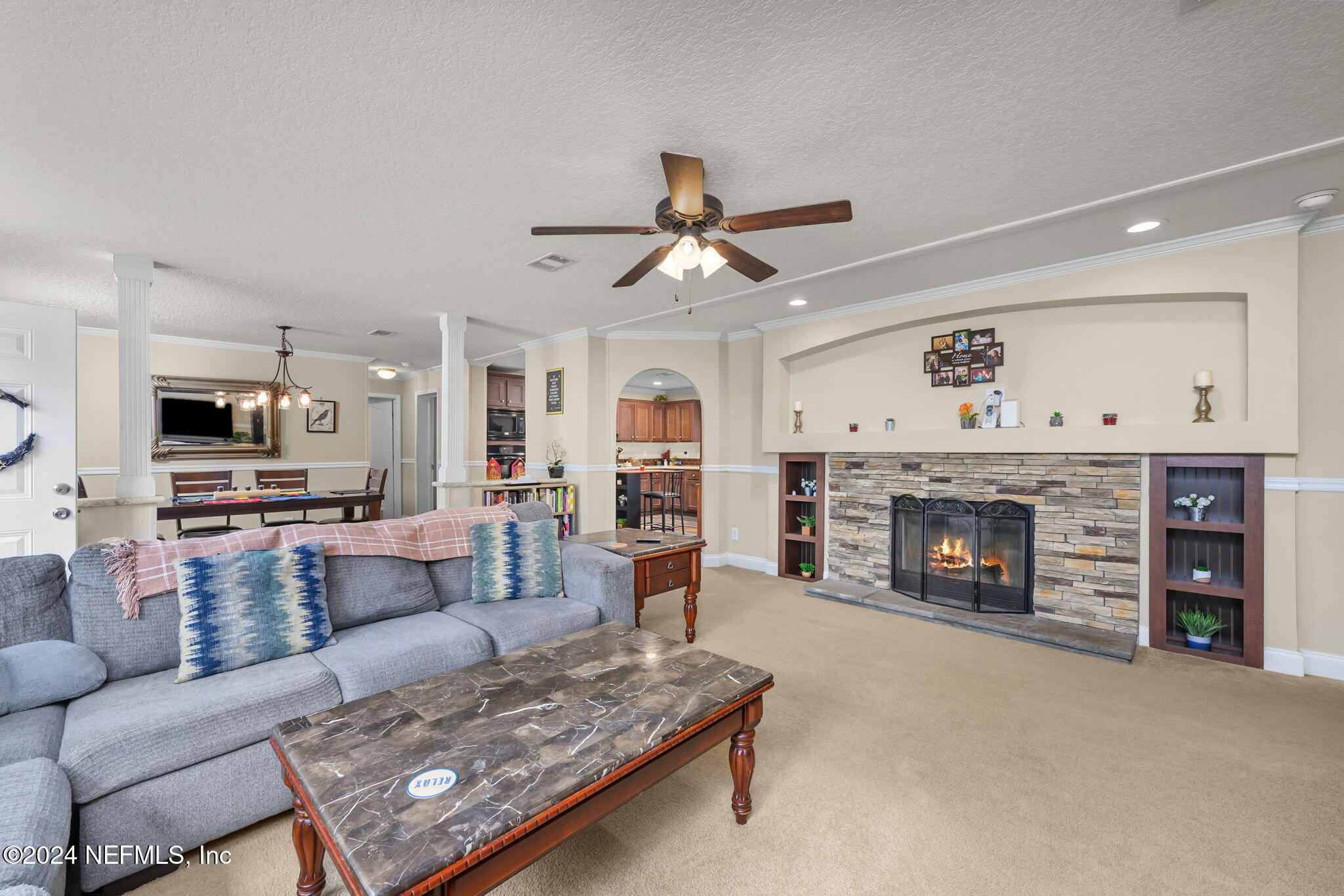 a living room with furniture and a fireplace