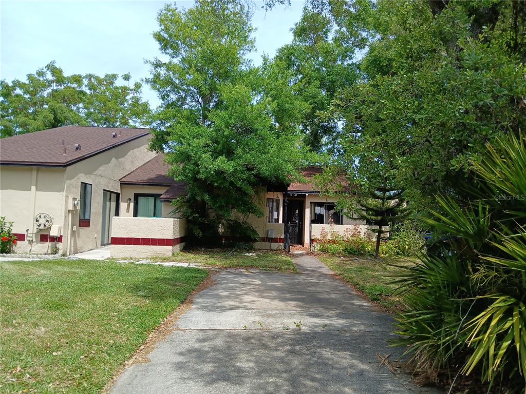 a front view of house with yard and trees