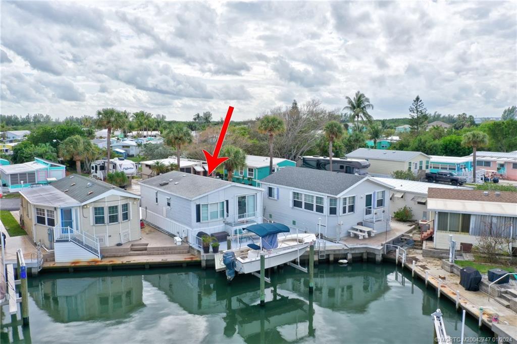 a aerial view of a house with swimming pool and lake view