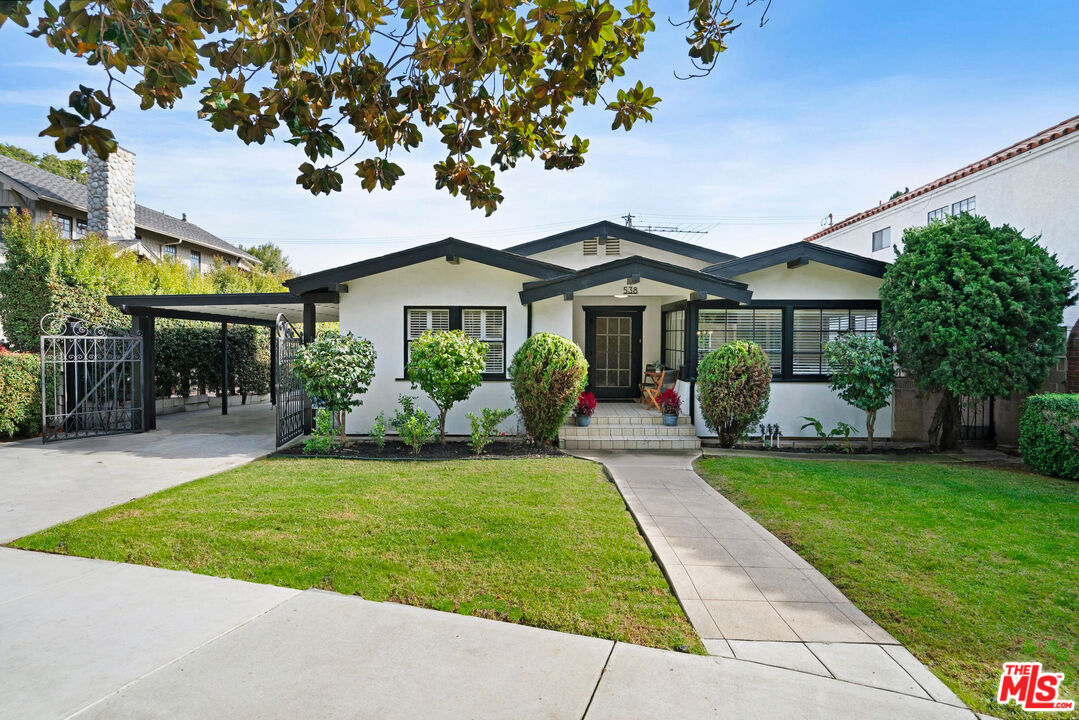 a front view of a house with a garden