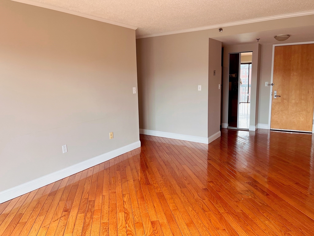 a view of a room with wooden floor and brick walls