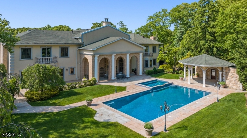 a view of a house with swimming pool and yard