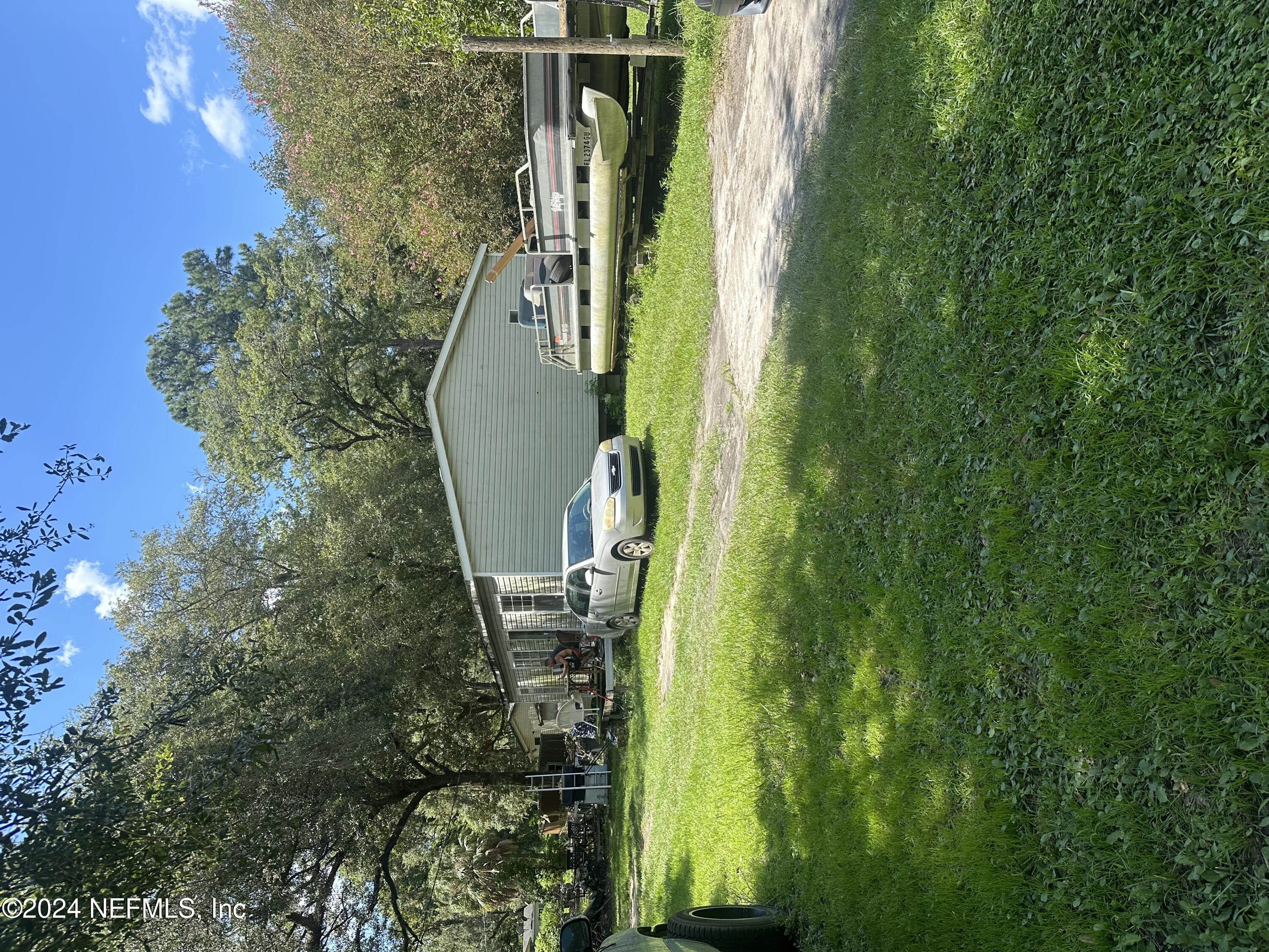 a view of a house with a yard and sitting area