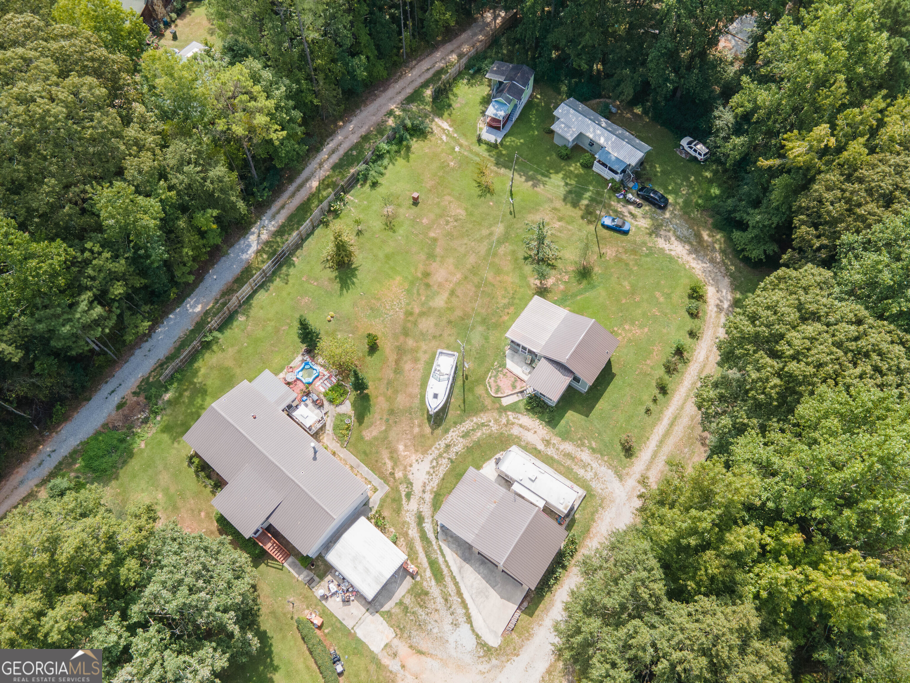 an aerial view of a house with a garden and swimming pool