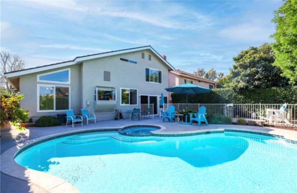 a house view with swimming pool and garden view