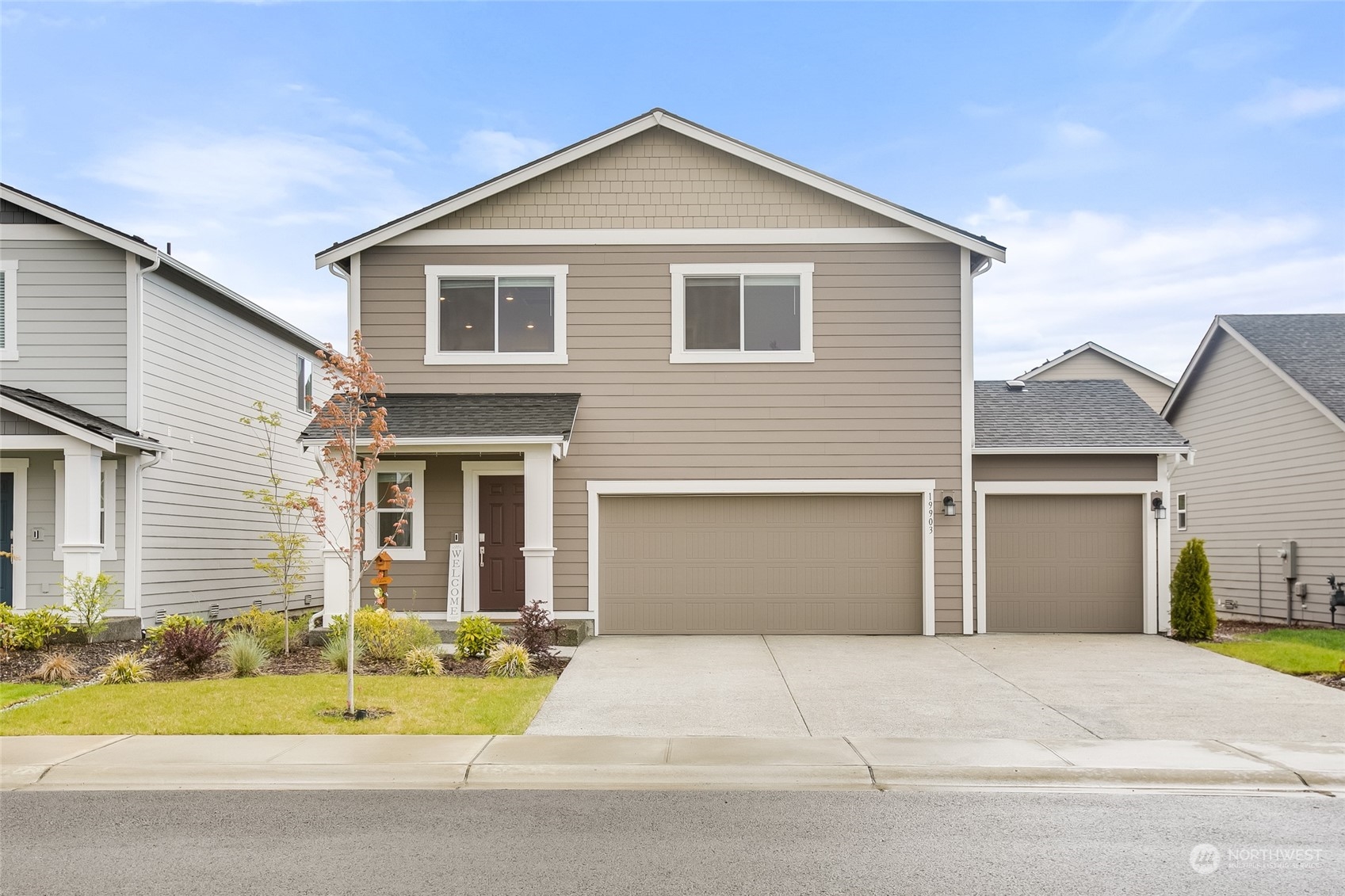 a front view of a house with a yard and garage