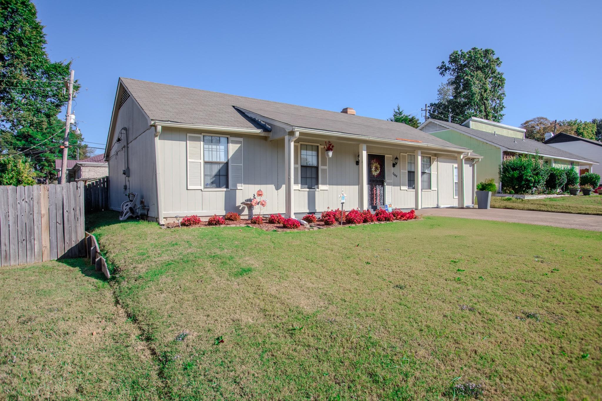 Single story home with a front lawn and a porch