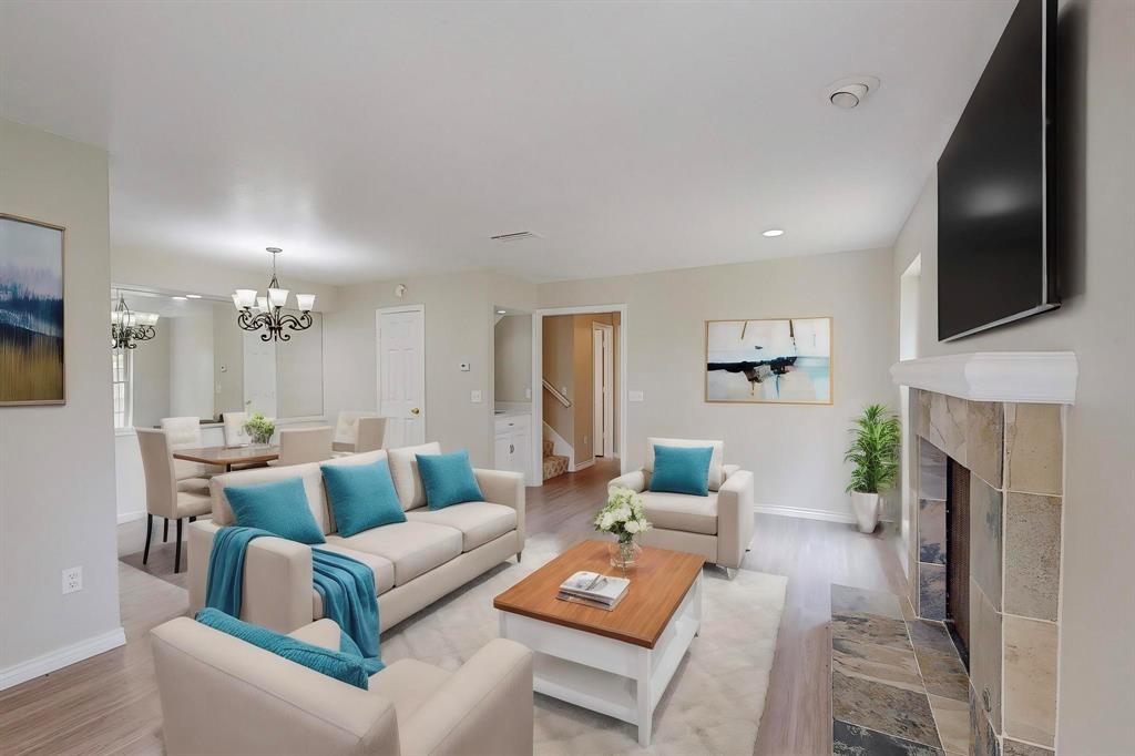 a living room with fireplace furniture and a flat screen tv