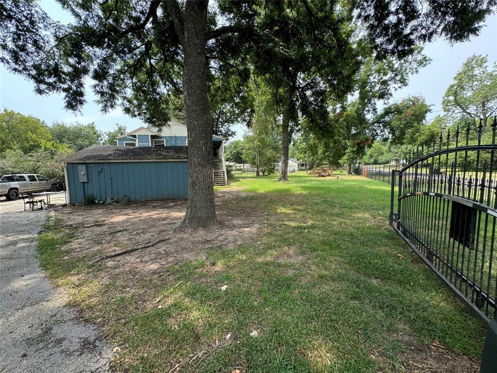 a view of a backyard with large trees