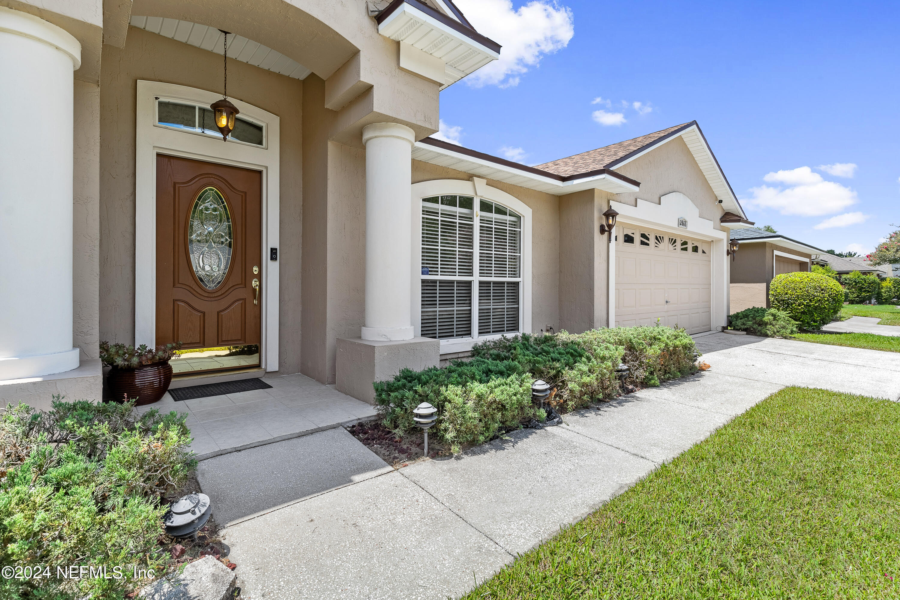 a front view of a house with garden