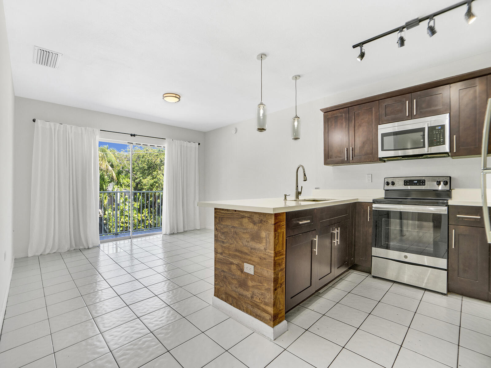 a kitchen with stainless steel appliances a stove sink and microwave