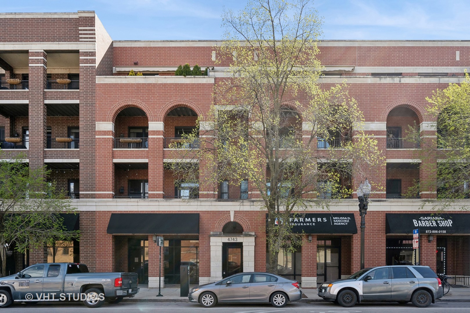 a front view of a building with parking space