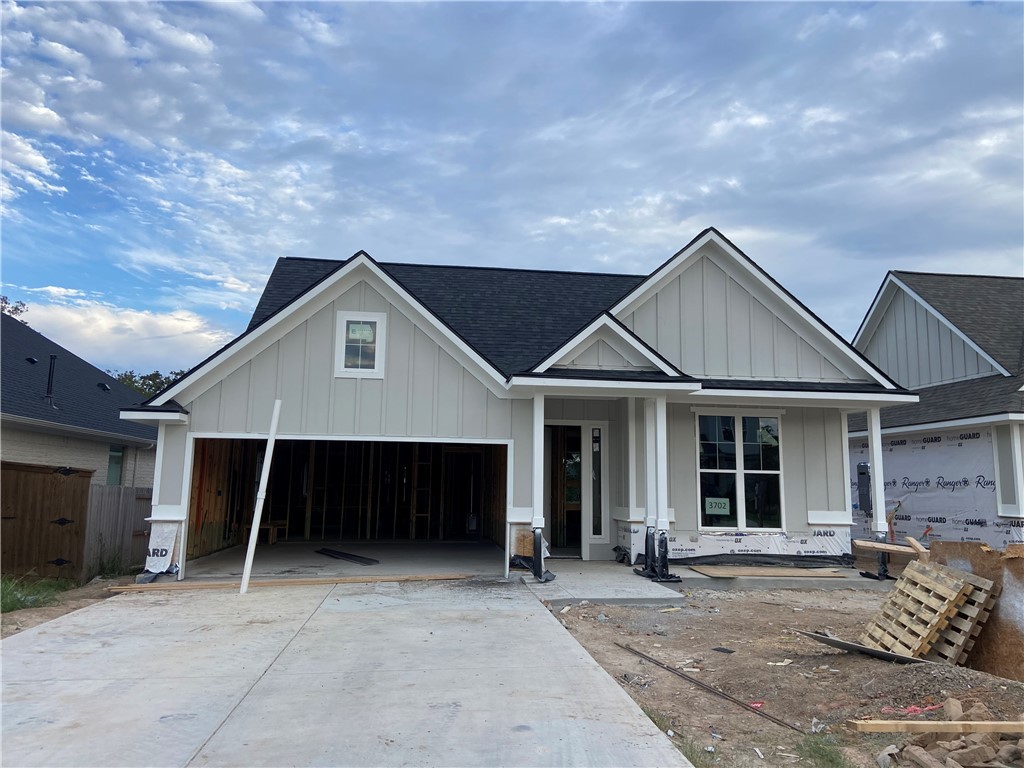 a front view of a house with a garage and yard