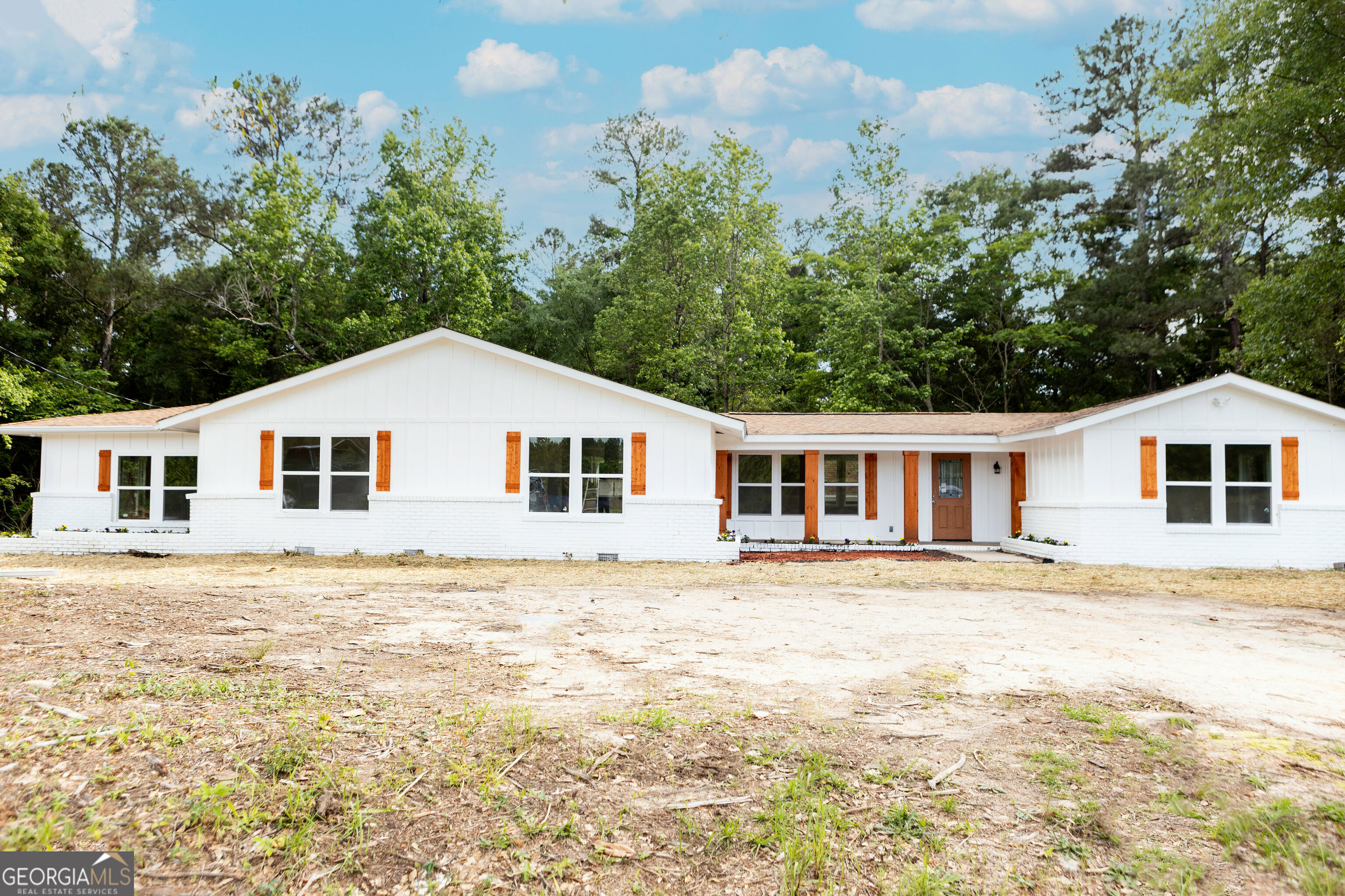 a front view of a house with a yard