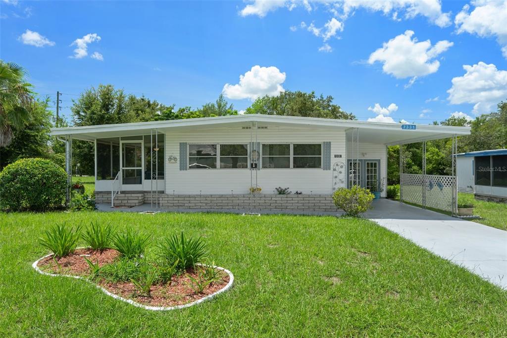 a view of a house with backyard sitting area and garden