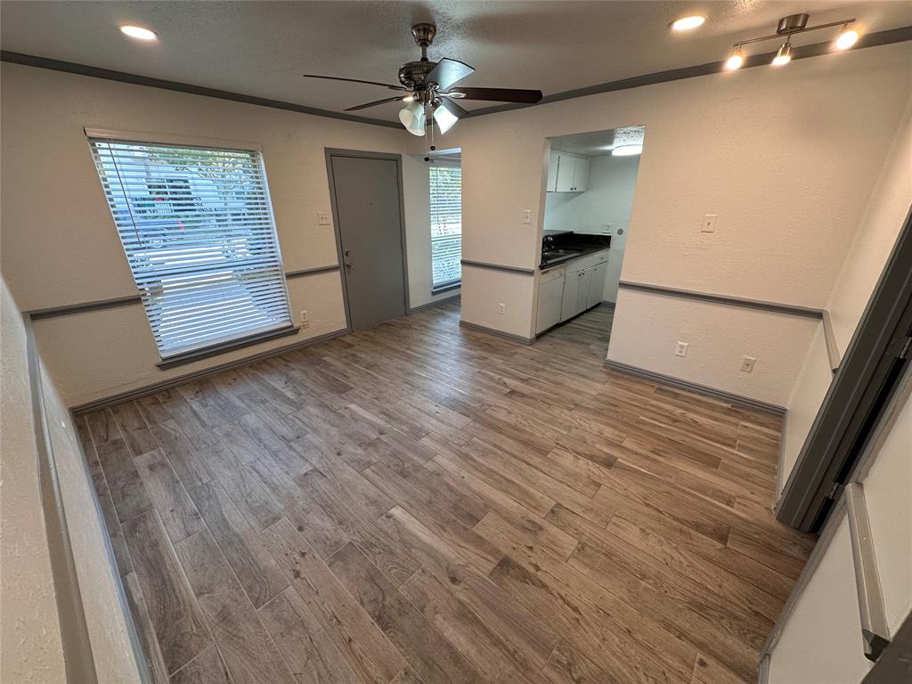 a view of kitchen and hall with wooden floor