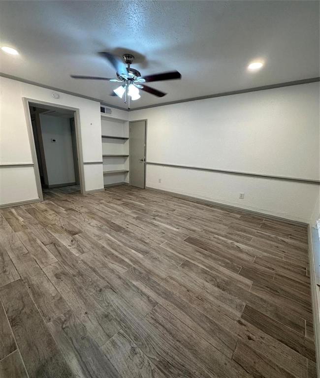 a view of a room with wooden floor