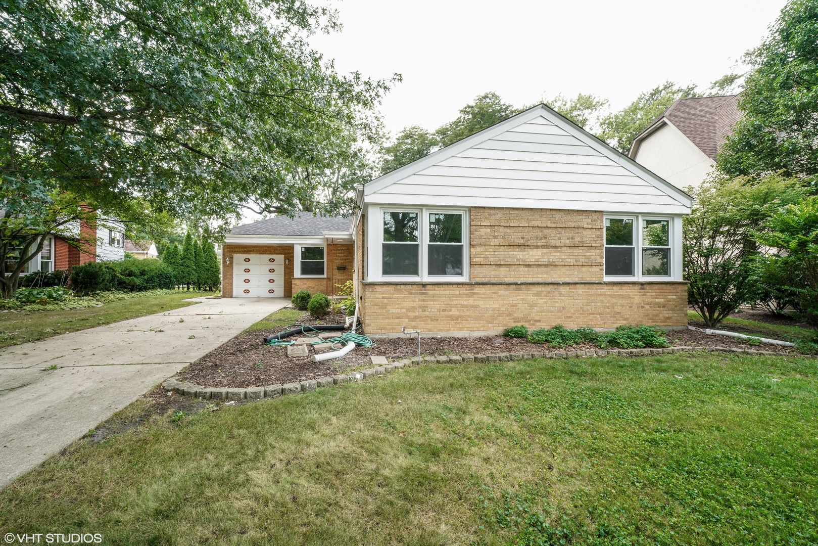 a front view of house with yard and green space