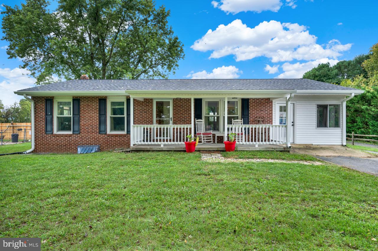 a view of a house with a yard and porch