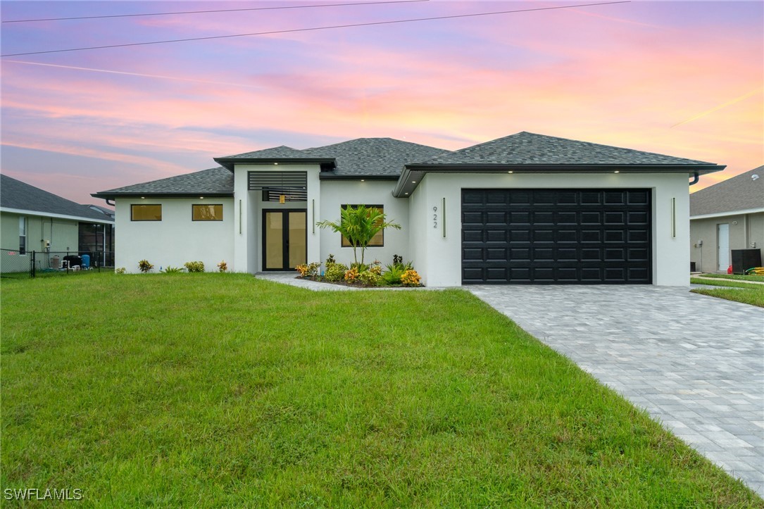 a front view of a house with a yard and garage