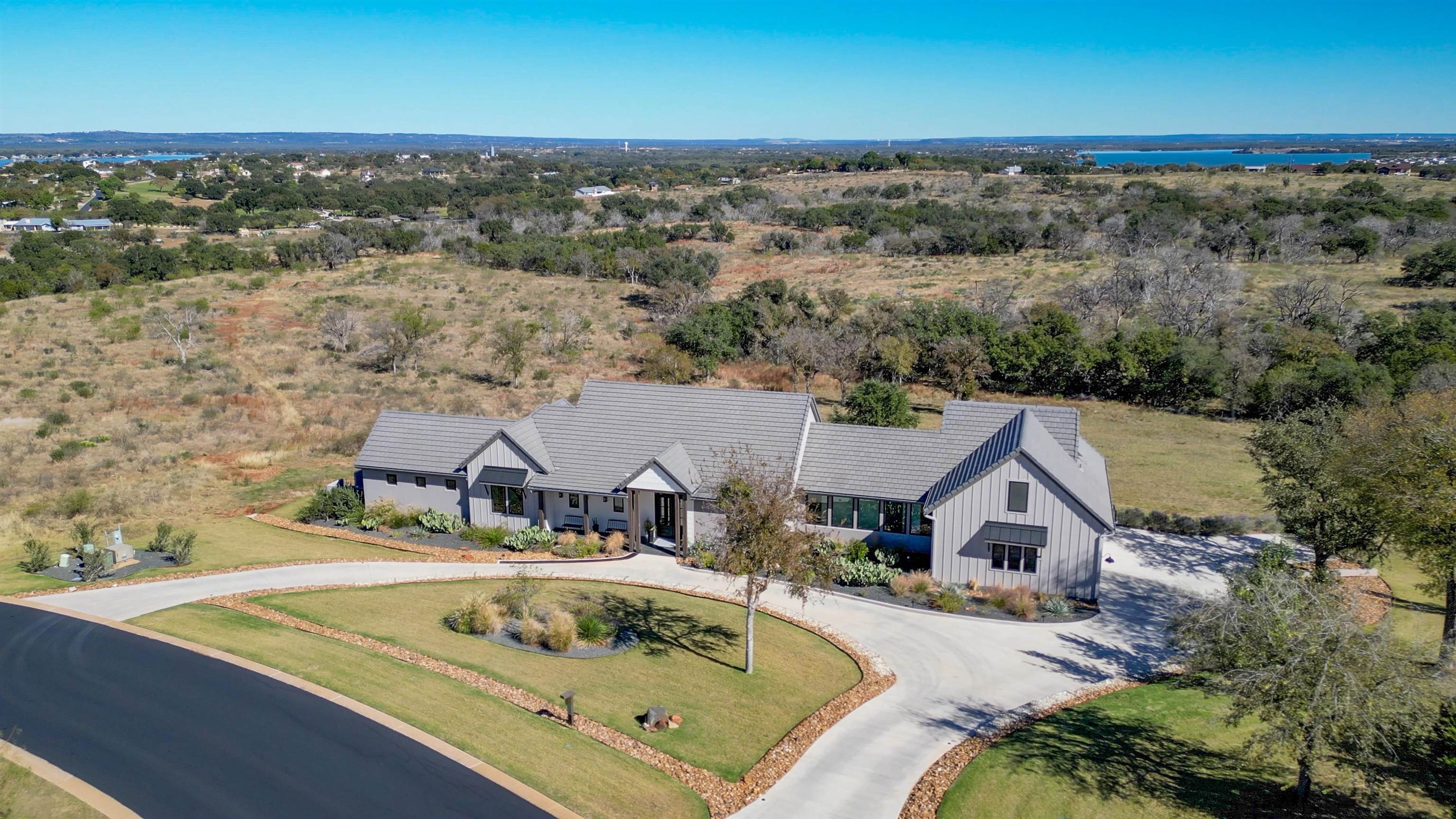 an aerial view of a house with swimming pool and ocean view