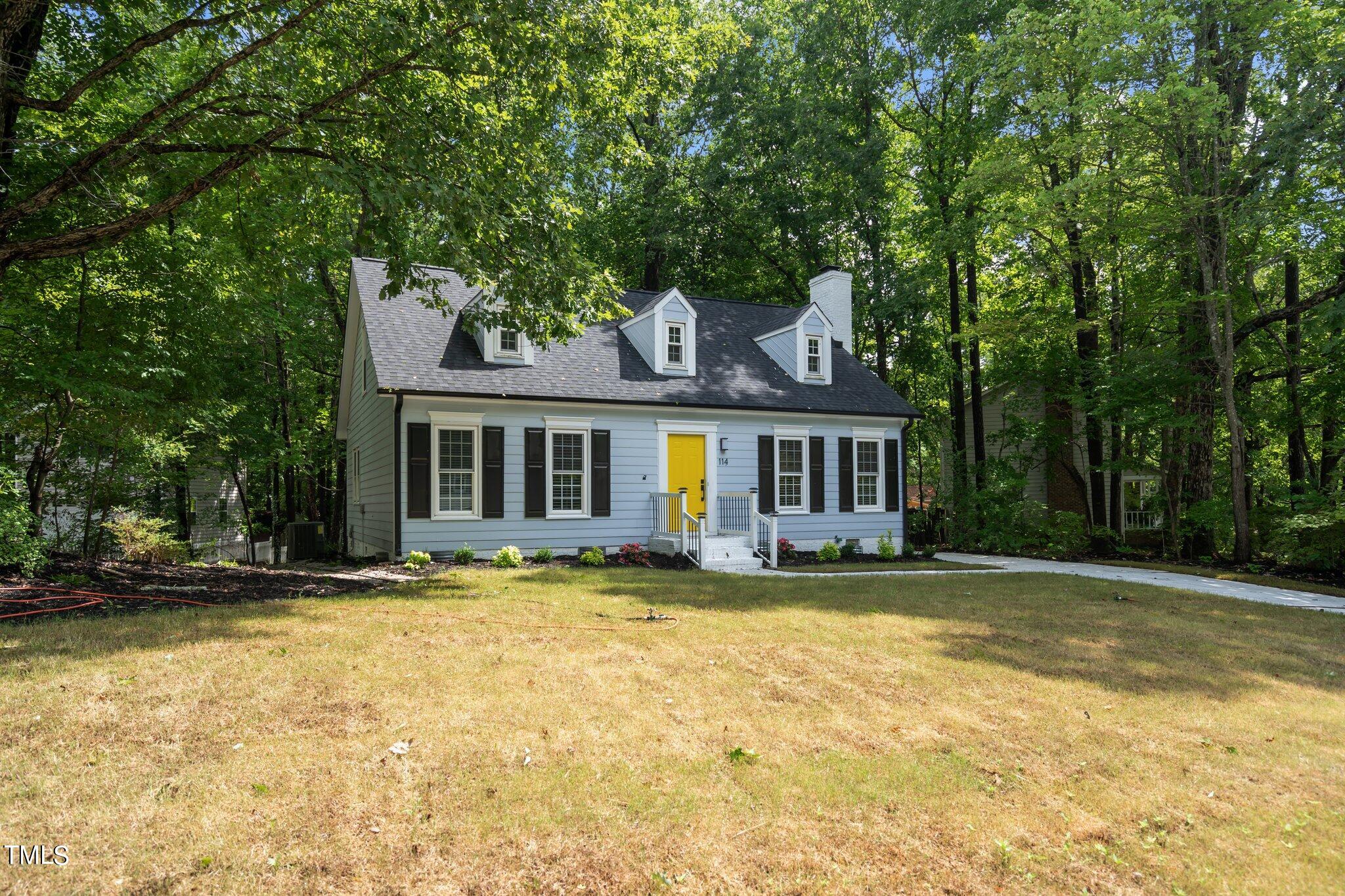 a front view of a house with a garden