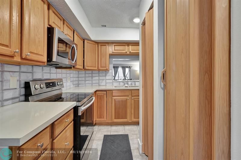 a kitchen with stainless steel appliances granite countertop a stove a sink and dishwasher